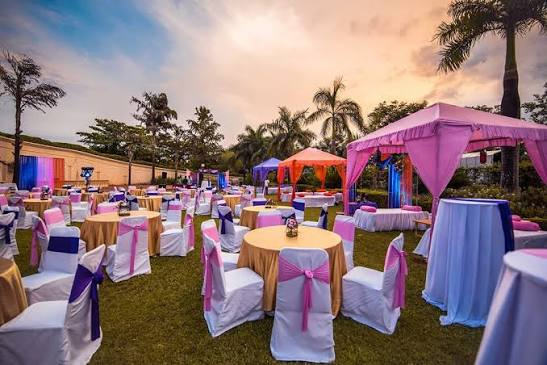 Indian wedding couple in traditional attire at a beautifully decorated wedding venue.